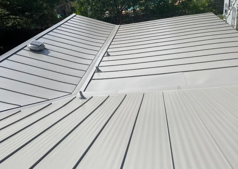 Solar attic fan installed on a metal roof for Roof Ventilation in Pinson